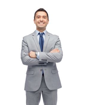 business, people and office concept - happy smiling businessman in suit