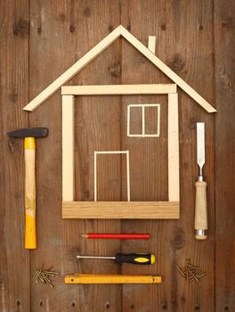 Wooden house construction and tools close up