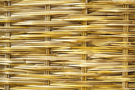 yellow plaited straw on mat as background