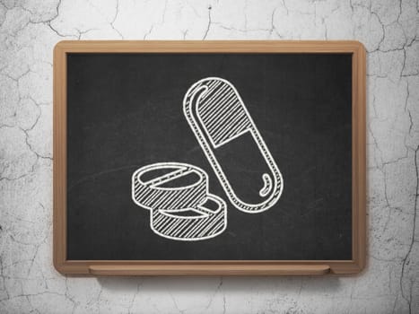 Healthcare concept: Pills icon on Black chalkboard on grunge wall background