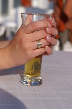 a woman drinking beer in a sunny day