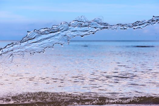 Blue water splash on sea background