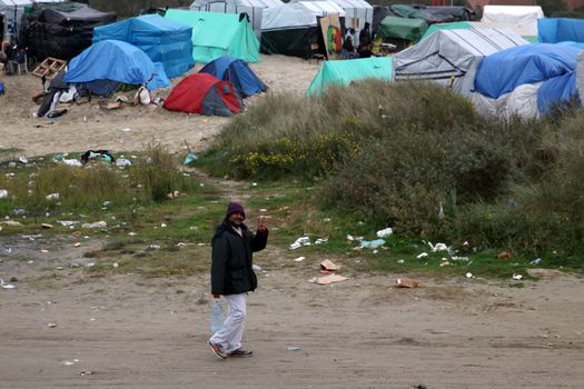 FRANCE, Calais: A migrant is pictured in the New Jungle migrant camp in Calais, where around 6.000 migrants live in the hope of crossing the Channel to Britain, on October 26, 2015.