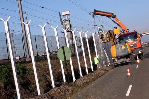 FRANCE, Calais: Workers install new fences around the French entrance of the Channel Tunnel in Calais, northern France, on October 26, 2015. Since the beginning of the migrants crisis, railway company Eurotunnel has reinforced its security measures, including installing new fences to avoid migrants enter the site.