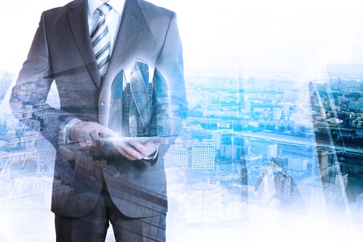 Business person holding tablet with 3d city model on cityscape background