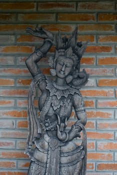 Thai style wood carving on the brick wall