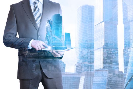 Businessman holding tablet with 3d city model on cityscape background