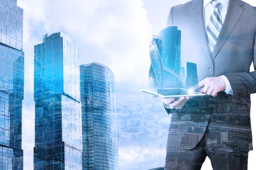 Businessman holding tablet with 3d city model on cityscape background