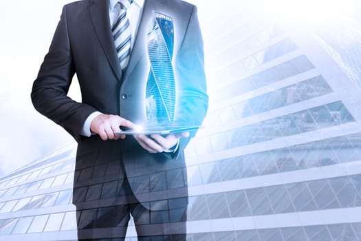 Businessman holding tablet with 3d city model on cityscape background