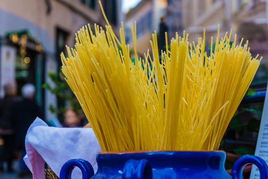 a bunch of raw spaghetti outside a restaurant in Rome