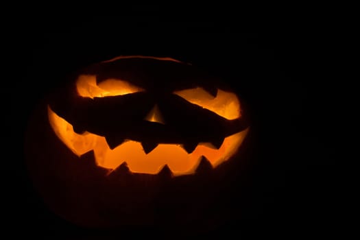 Halloween pumpkin with scary face on black backgound