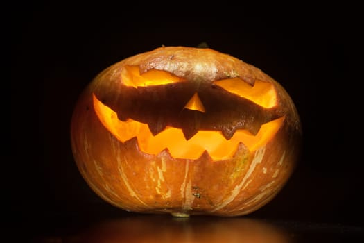 Halloween pumpkin with scary face on black backgound