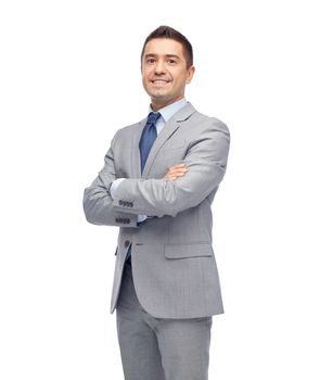 business, people and office concept - happy smiling businessman in suit