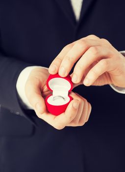 picture of man with gift box and wedding ring