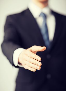 business people and office concept - businessman with open hand ready for handshake