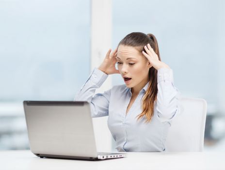 business, office and technology concept - stressed businesswoman with laptop at work