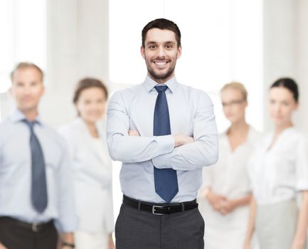 business and office concept - handsome businessman with crossed arms