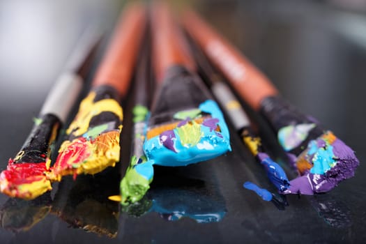 brush in the paint close-up on the table