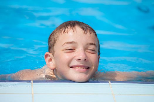 cute guy smiling in the pool, summer day
