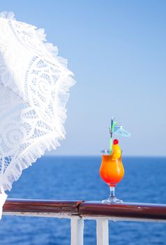 Girl with an umbrella to enjoy the journey drinking a cold cocktail