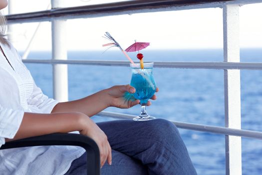 girl drinking a cocktail on a journey to the sea