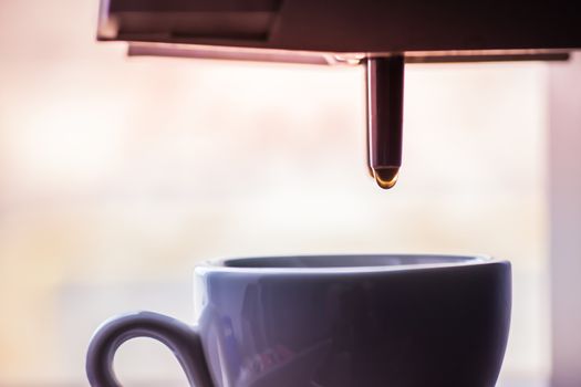close-up of a cup of black coffee standing on coffee machine
