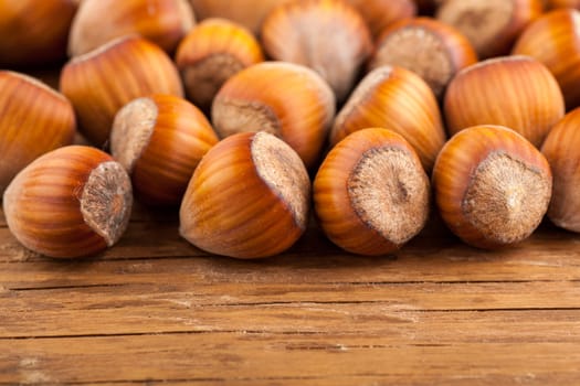 dried whole hazelnuts close-up on wooden background