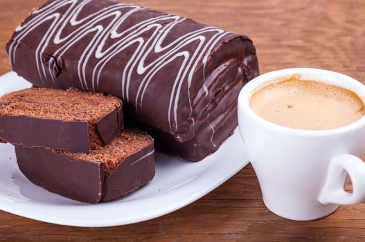 roll with a cup of coffee close-up on a wooden background