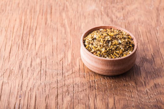 spice salt in a wooden bowl on a vintage background