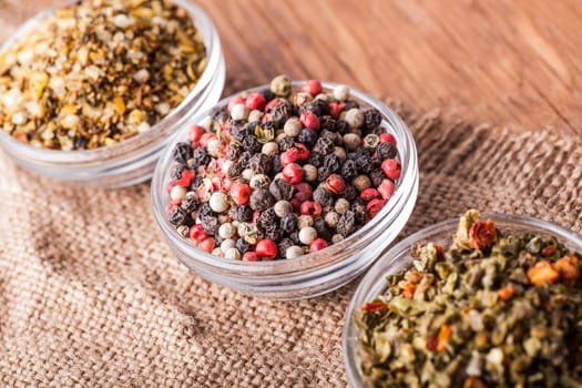 spices in a glass bowl close-up on a vintage background