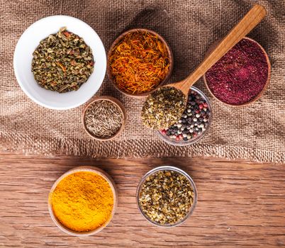 set dry spices in a wooden bowl on a vintage background