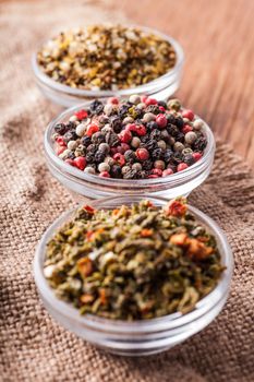 dry spices in a glass bowl close-up on a vintage background