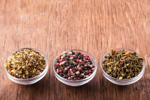 spices salt,paprika in a glass bowl on a wooden background