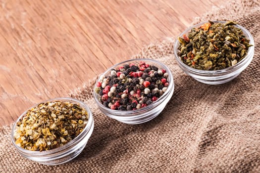 spices in a glass bowl on a vintage background