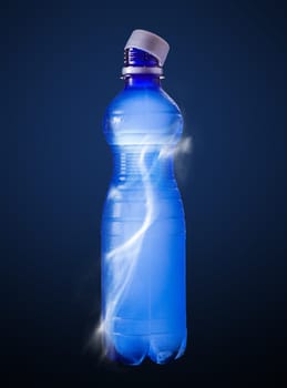 water in the plastic bottle on a blue background