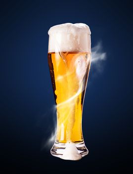 lager beer in goblet on a blue background