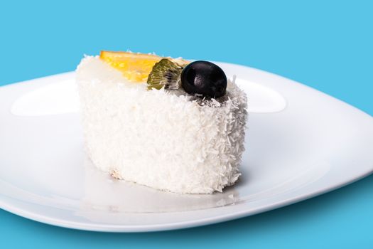 fresh coconut piece of cake closeup on blue background
