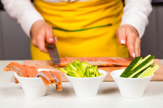 chopped ingredients red fish, cucumber and avocado