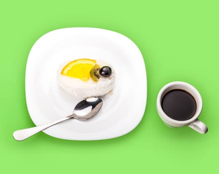 coconut piece of cake and coffee cup on a green background