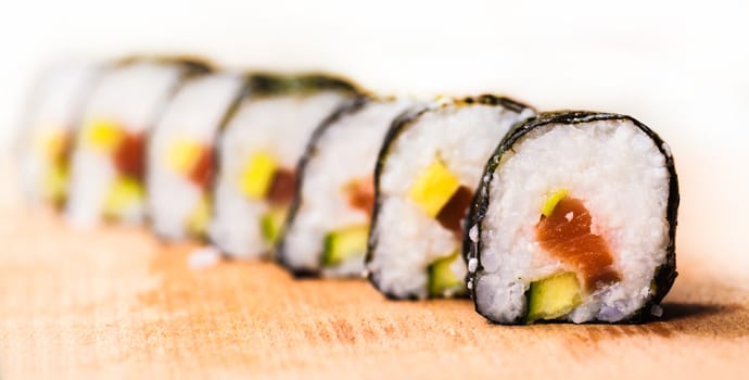 fresh rolls with salmon close-up on a wooden board