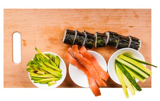 avocado, cucumber, fish and fresh rolls on a wooden board