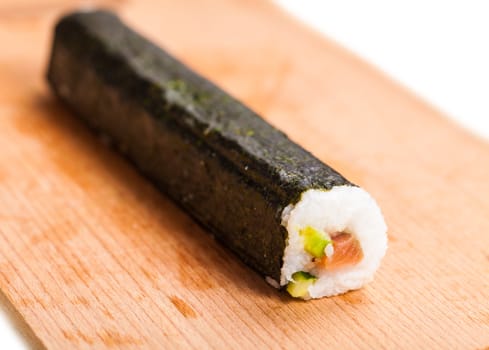 fresh sushi roll closeup on a wooden board