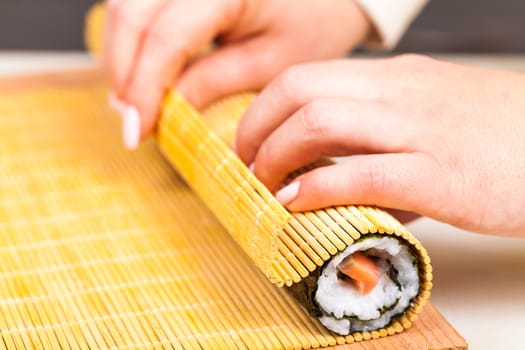 cook hands twisted rolls closeup on a wooden board