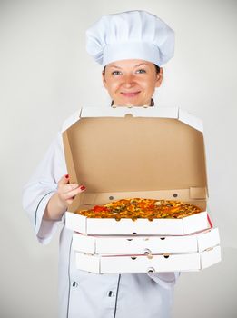 cook with a pizza in box on a light background
