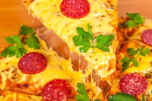 hot pizza with salami closeup on wooden background