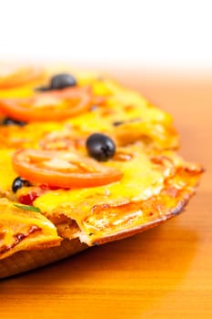 hot fresh pizza closeup on wooden background