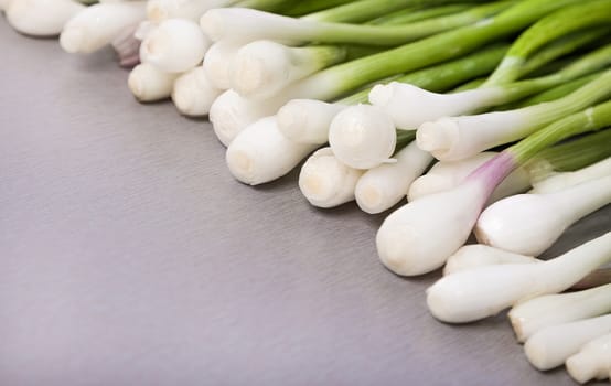 natural the fresh green onions lies diagonally