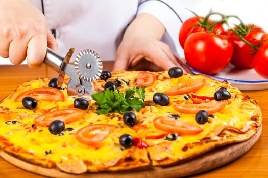 chef knife cuts fresh hot vegetable pizza