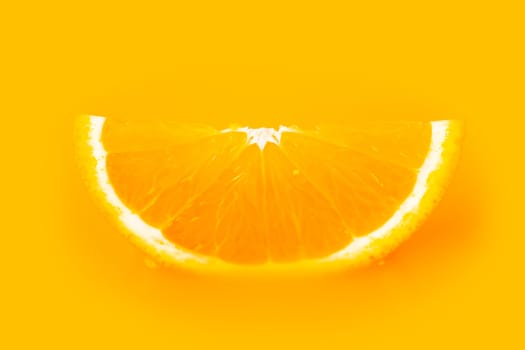 ripe a slice of orange on yellow background
