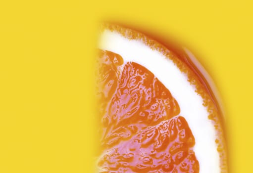 Juicy a slice of orange on yellow background